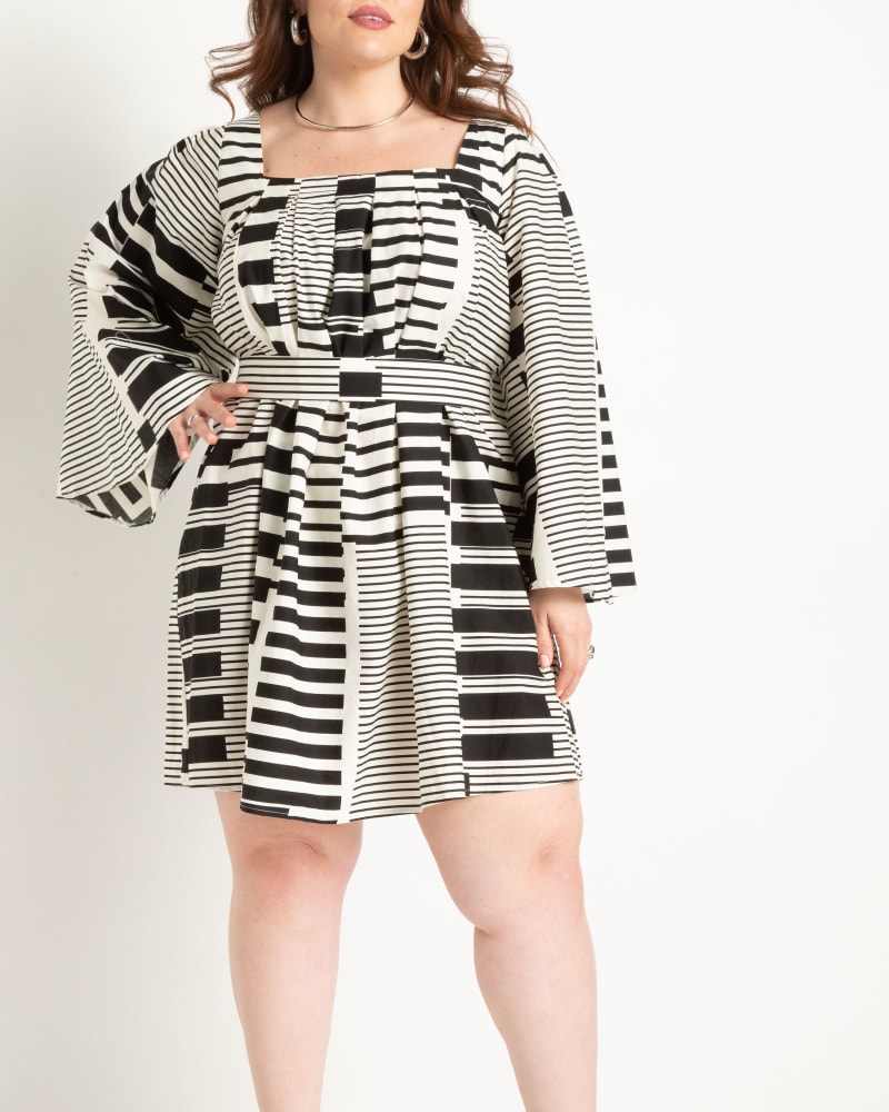 Front of a model wearing a size 26 Flare Sleeve Mini Dress in Tune Keys by ELOQUII. | dia_product_style_image_id:303778